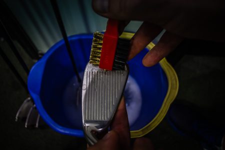 Using a golf club groove sharpener to get out excess dirt while getting the edge back is recommended