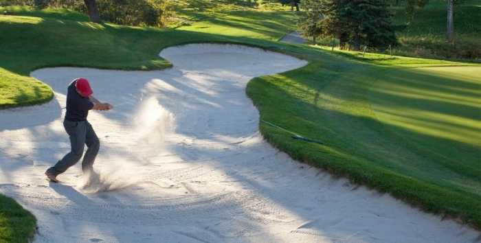 Best Golf Terms: A Comprehensive Dictionary To Golf Slang 2 Golfer hitting a shot out of a bunker